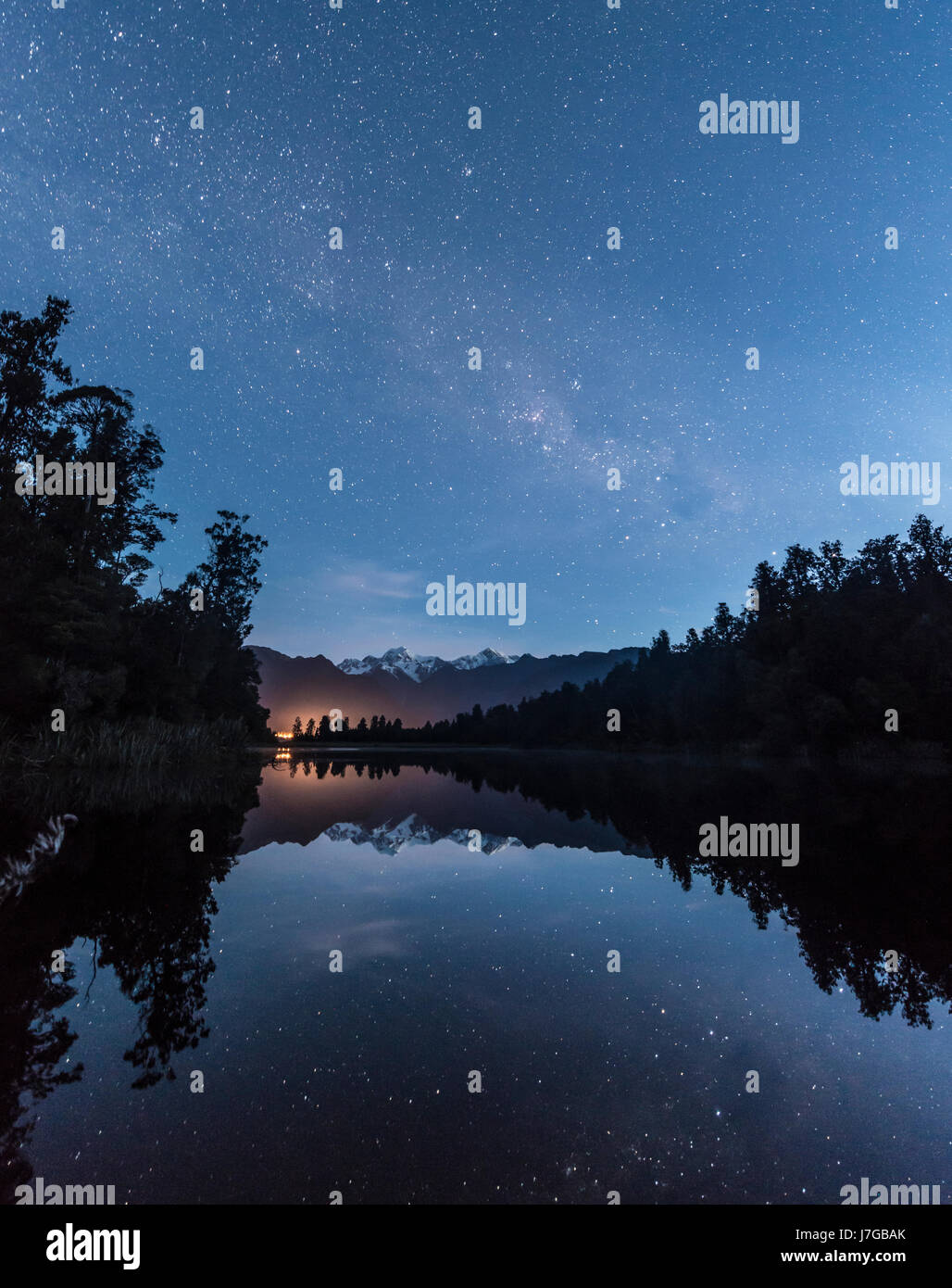 Mt. Tasman e Mt. Cuocere durante la notte con le stelle e la Via Lattea, la riflessione sul lago Matheson, parco nazionale di Mount Cook Foto Stock