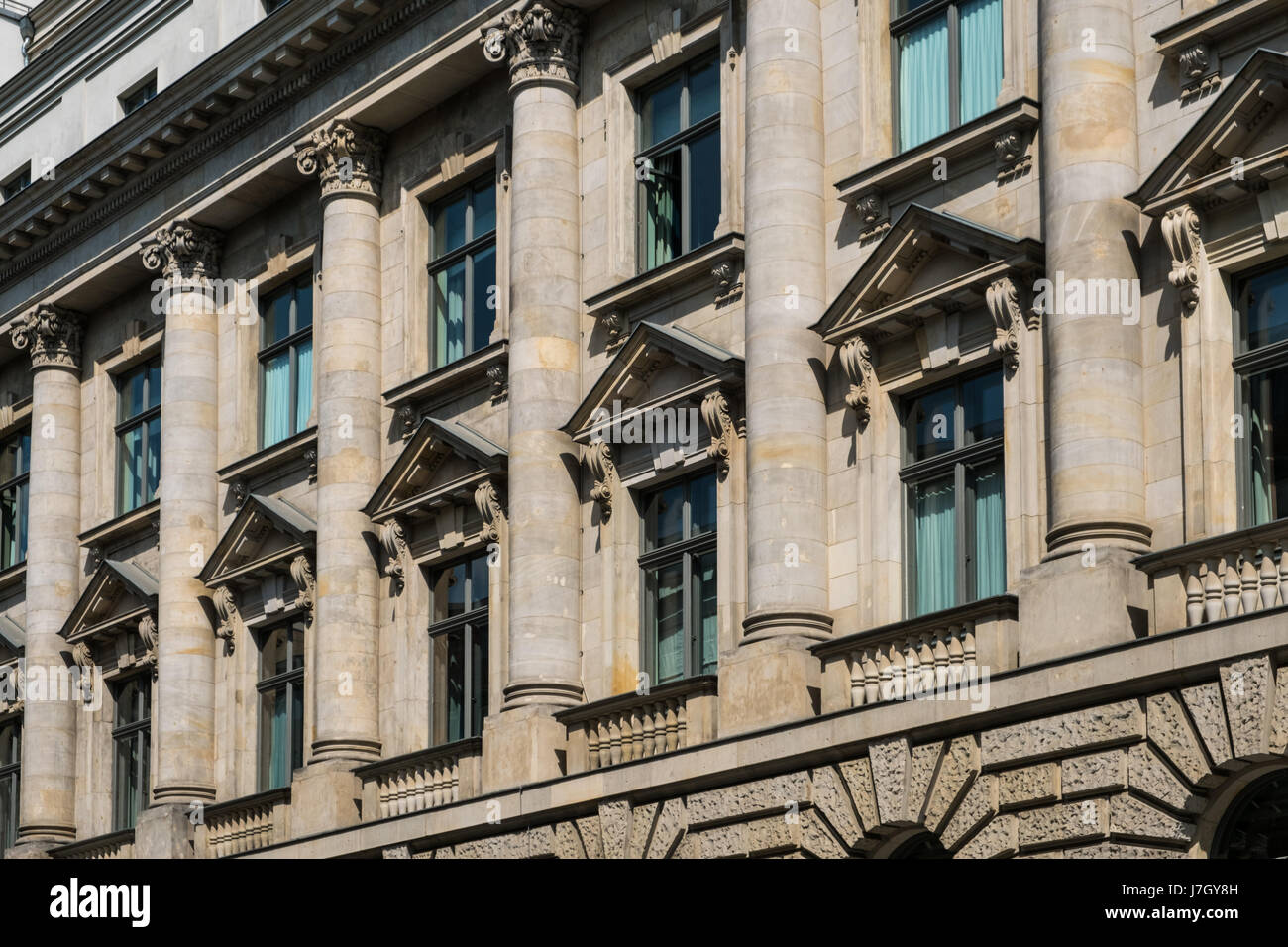 Windows sulla storica facciata di edificio con colonne Foto Stock