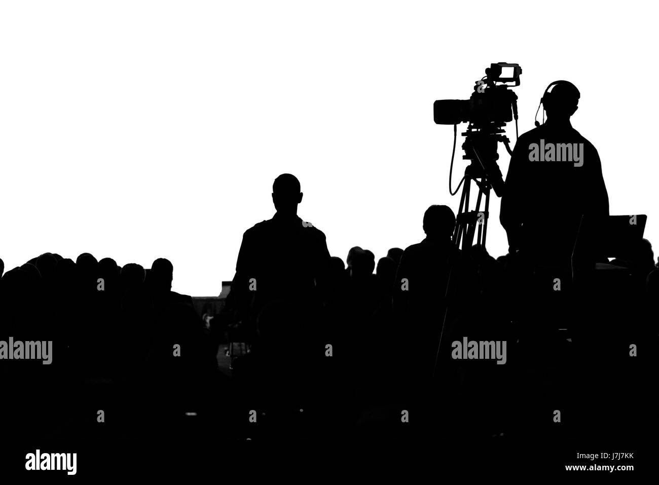 La televisione conferenza stampa il cameraman di produzione silhouette Foto Stock