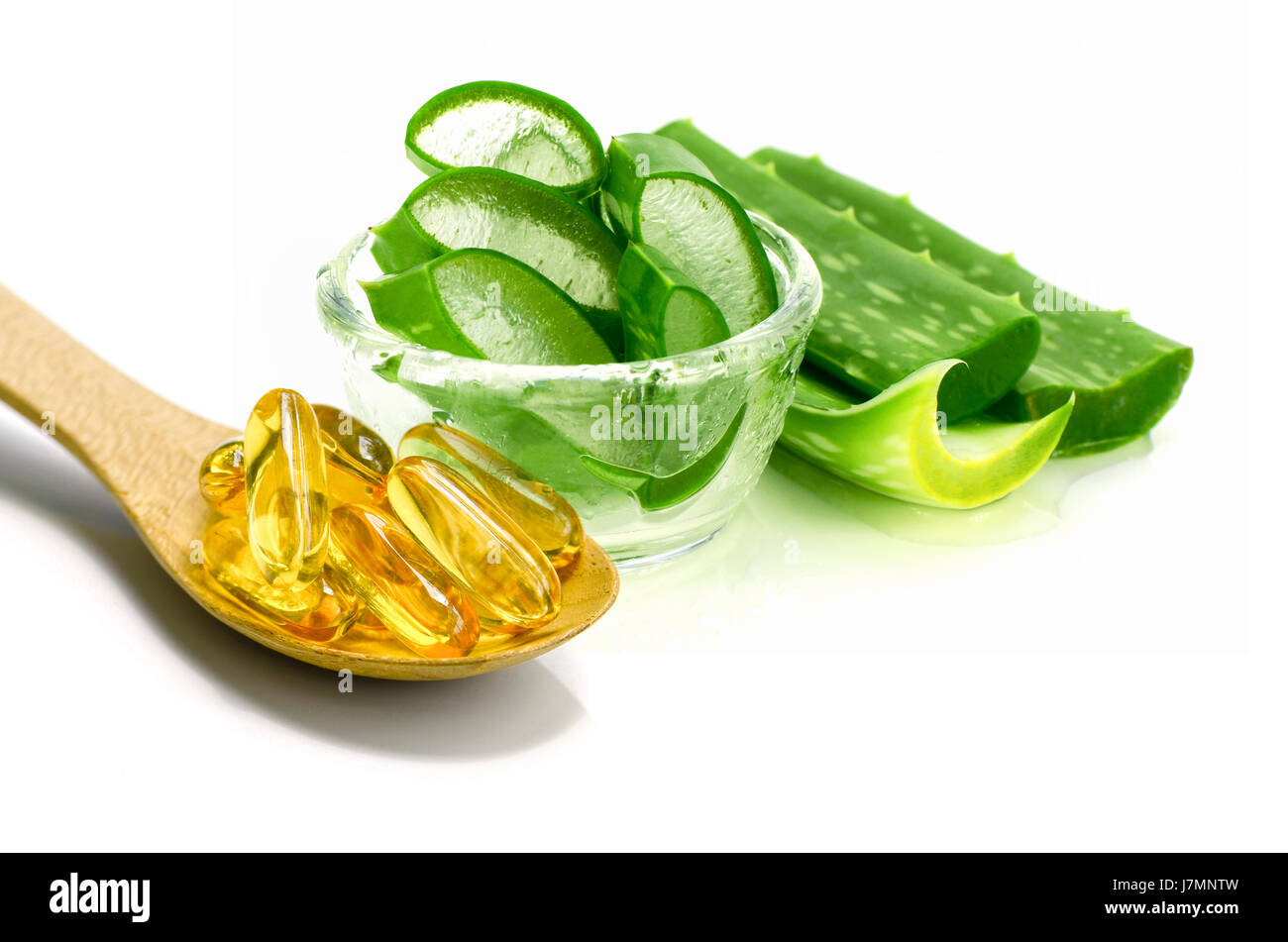 La vitamina E capsule e fette di Aloe Vera su sfondo bianco. Foto Stock