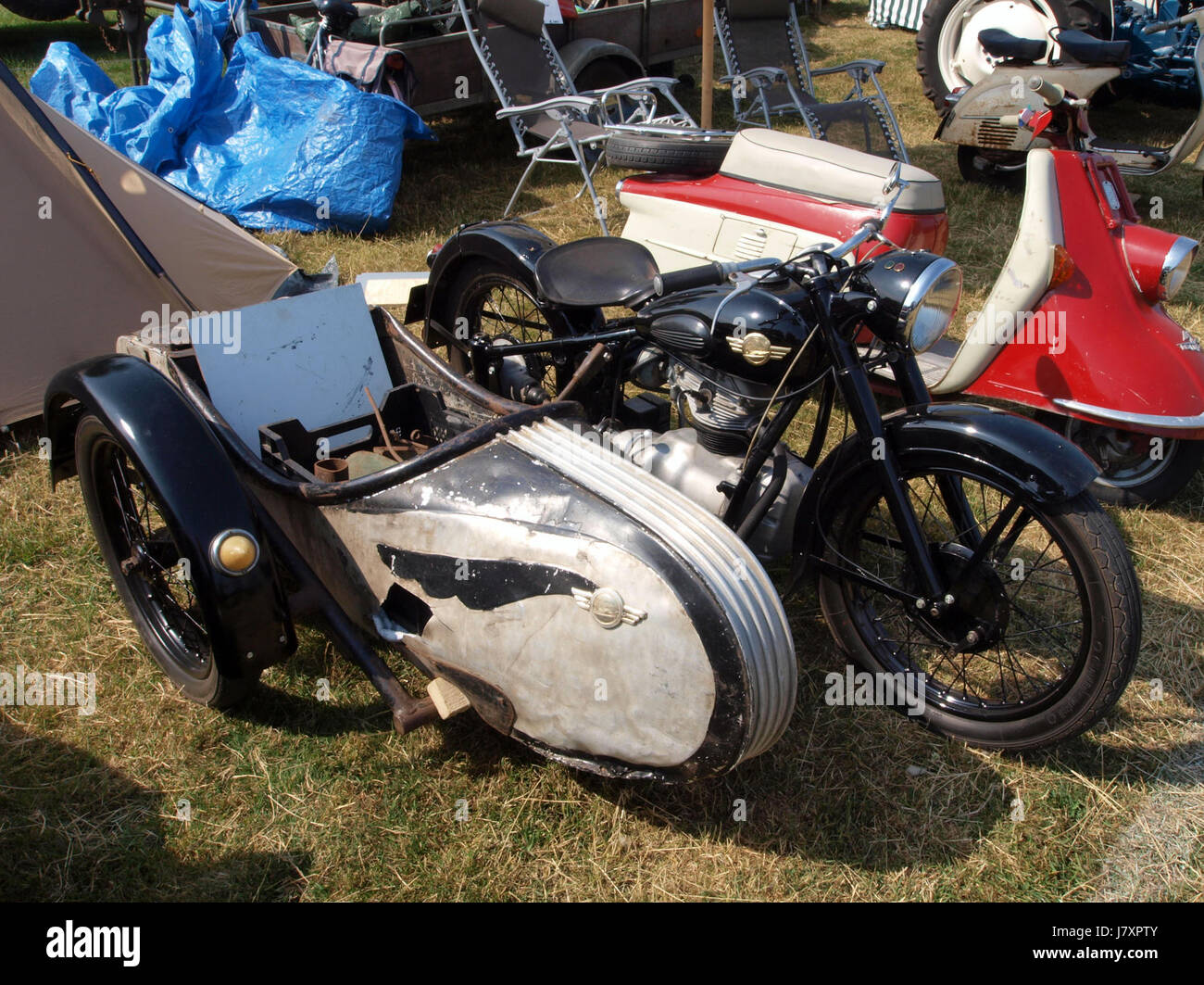Questa immagine raffigura una motocicletta AJS 55/16 MS del 1955, un modello classico noto per le sue prestazioni e il design nelle motociclette britanniche della metà del XX secolo. Il marchio AJS era rinomato per la sua ingegneria e questo modello rappresenta un'era significativa nella storia delle motociclette. Foto Stock