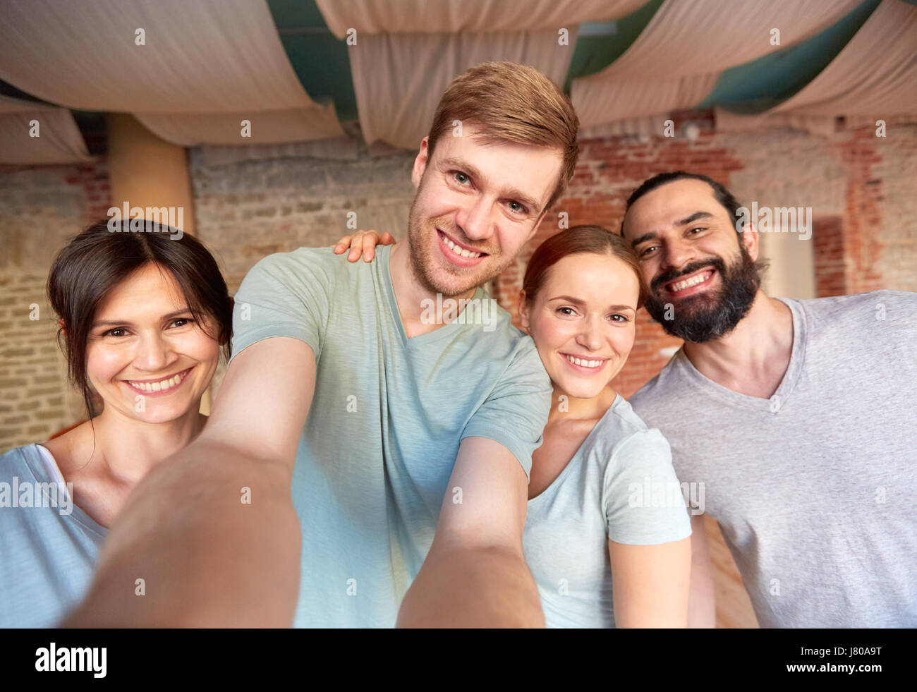 Happy amici a studio di yoga o palestra tenendo selfie Foto Stock