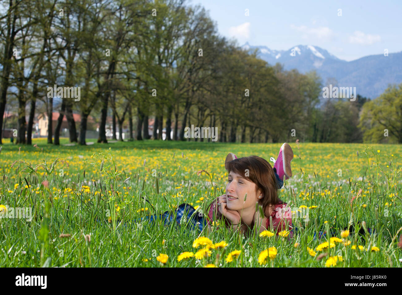 La donna si trovano giacenti giace fiore di primavera prato lieto abbastanza ambizioso entusiasta Foto Stock