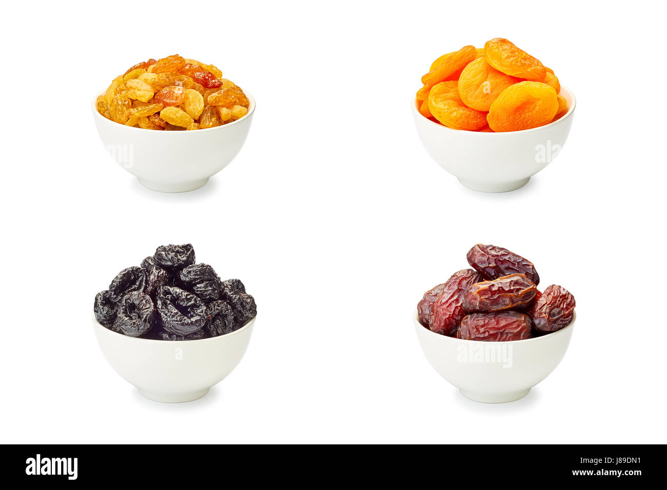 Set di ciotole con frutta secca su bianco Foto Stock
