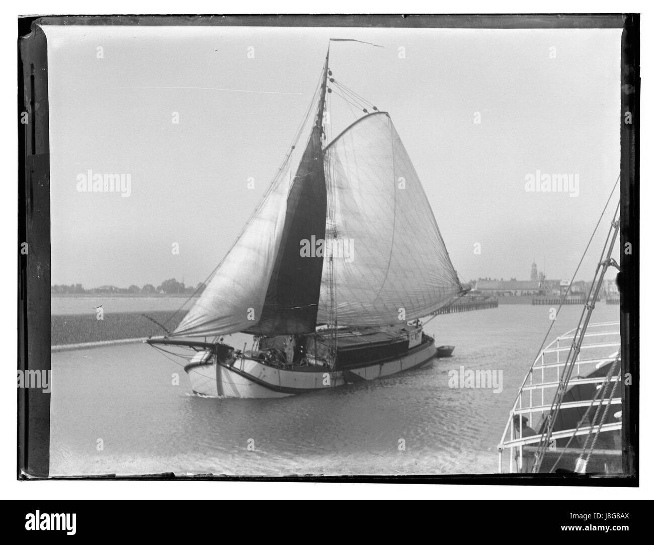 Een vrachtschip vaart de haven van Lemmer uit, gezien vanaf een schip van de Dienst Amsterdam Lemmer Groningen Giacobbe Olie (max res) Foto Stock