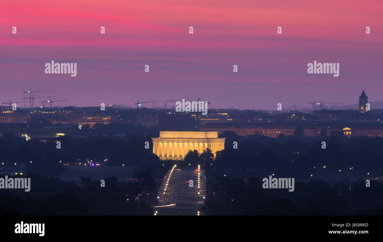 Sunrise dipinge il cielo rosa e viola sopra il Lincoln Memorial e il Memorial Bridge come si vede dal Robert E. Lee House in Arlington National Cemete Foto Stock