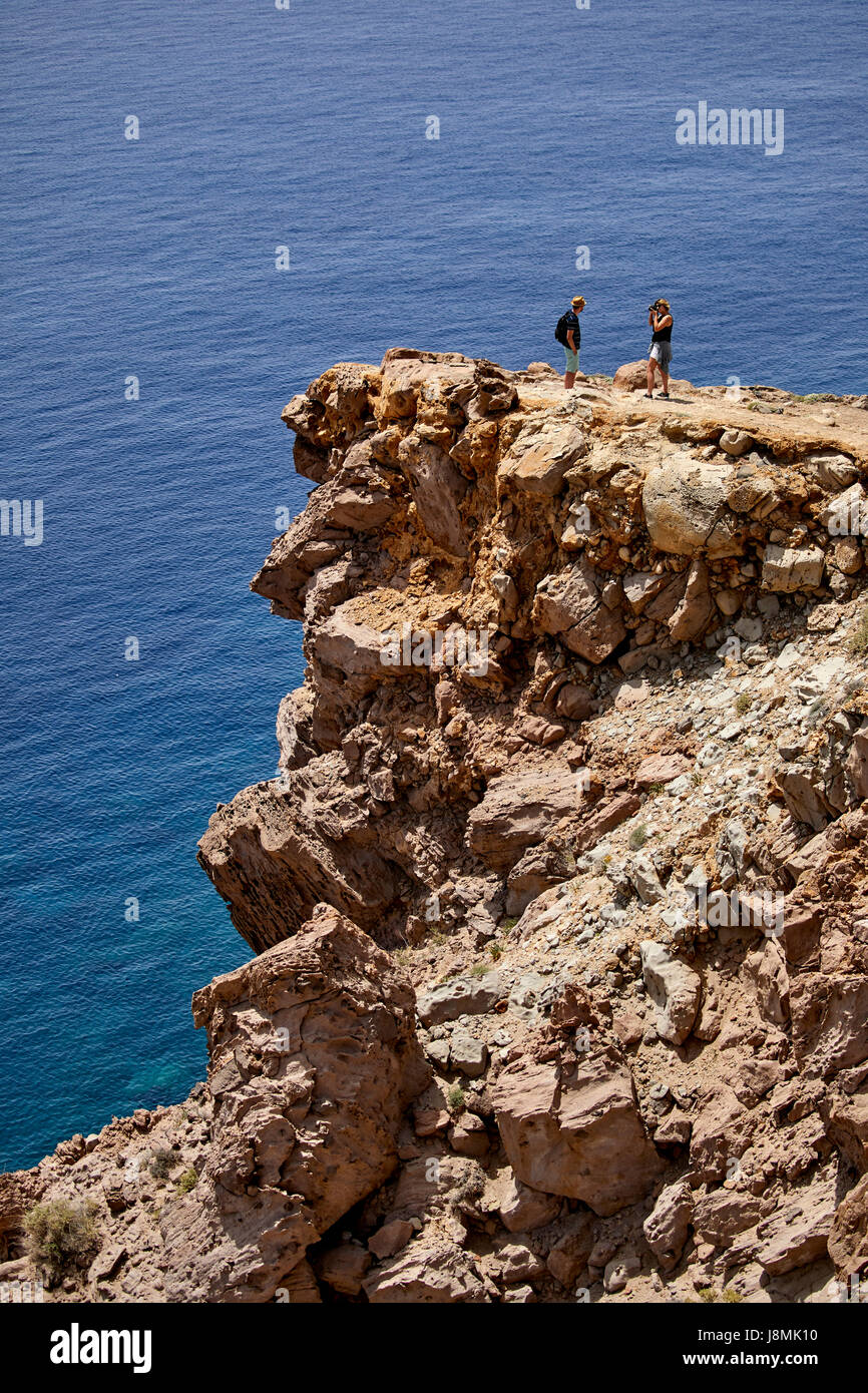 Vulcanica isola greca Santorini una delle isole Cicladi nel Mare Egeo. I turisti alla scogliera vicino ad Akrotiri faro sulla punta meridionale Foto Stock