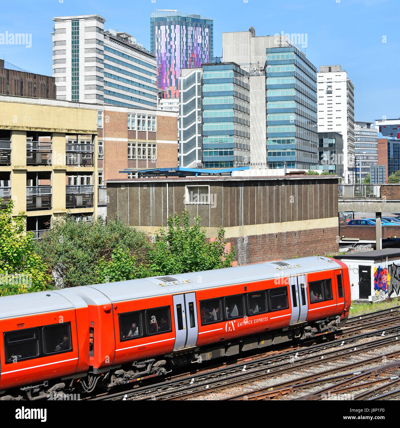Gatwick Express treno passeggeri vicino a stazione di East Croydon voce per la stazione di London Victoria azionato dalla concentrazione Govia ferroviari Thameslink Croydon Regno Unito skyline al di là Foto Stock