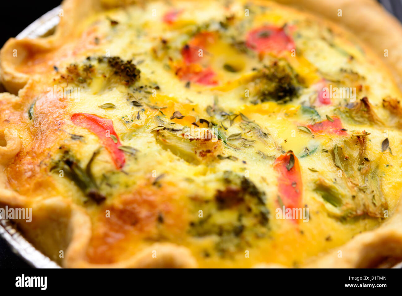 Home broccoli cotti, zucchine e peperoni quiche in un vassoio foglio Foto Stock