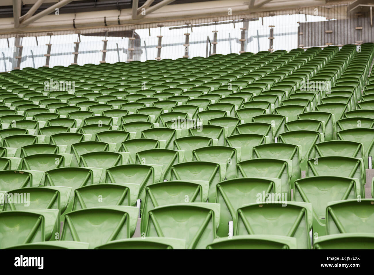 Una fila di vuoto sedili verde in uno stadio di calcio Foto Stock