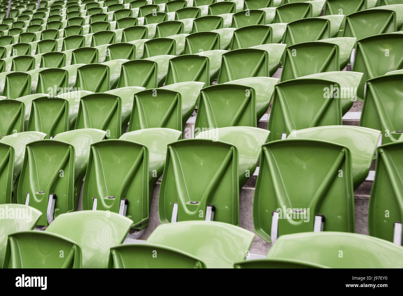 Una fila di vuoto sedili verde in uno stadio di calcio Foto Stock