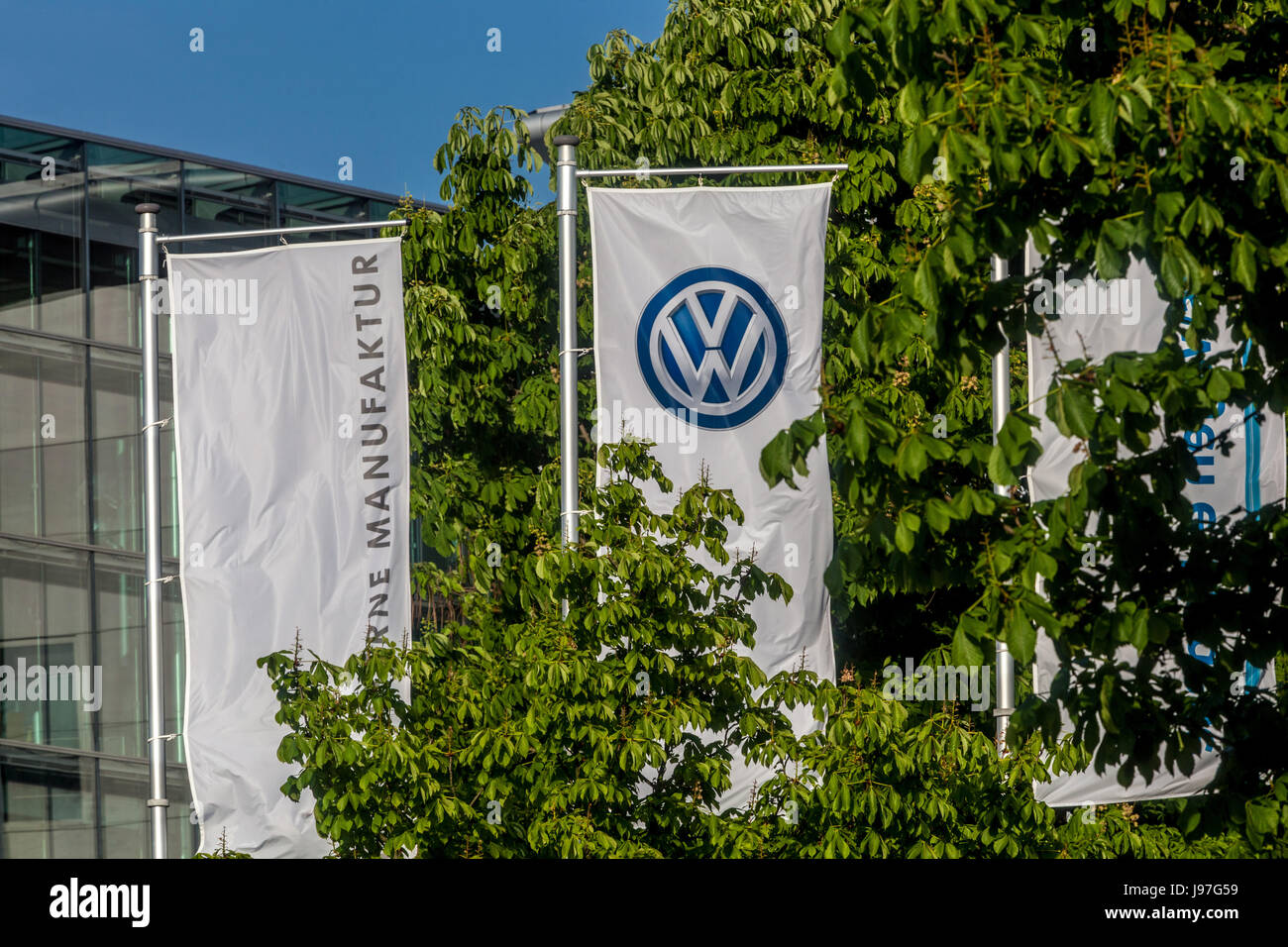VW logo sulla bandiera di fronte Glaeserne Manufaktur, fabbrica trasparente, Volkswagen Fabbrica, la produzione di auto, Dresda, Sassonia, Germania, Europa Foto Stock