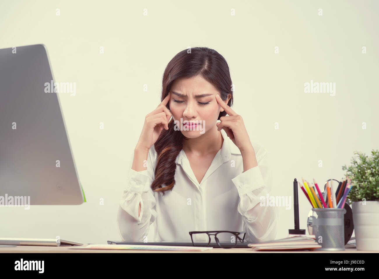 Stanco di sleepy donna sbadigli, lavorando alla scrivania in ufficio. Superlavoro e la privazione del sonno concept Foto Stock