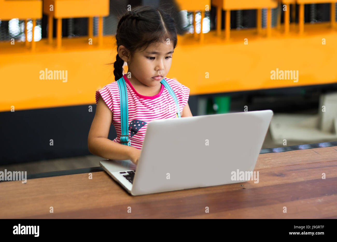 Selezionare focus ragazza asiatica veloce digitando il codice con computer portatile sul tavolo Foto Stock
