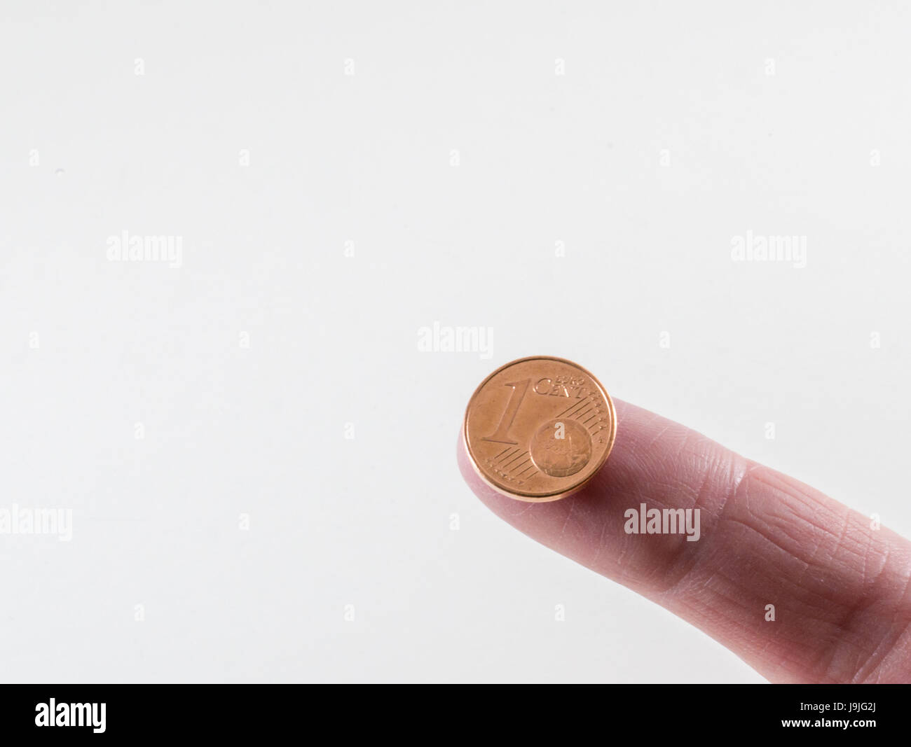Tenendo premuto 1 cent sulla parte superiore del dito Foto Stock