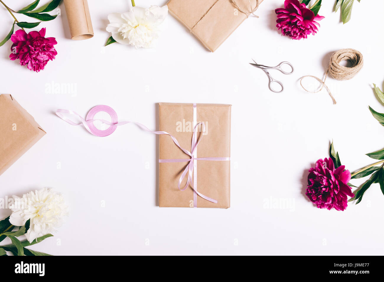 Prenota in carta di avvolgimento con nastro giace su un tavolo bianco vista superiore Foto Stock