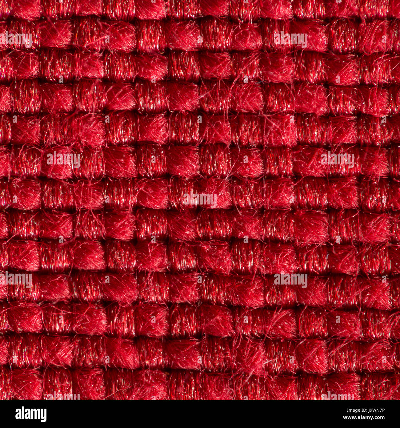 In tessuto rosso con strutturato e fibre lavorate a maglia extreme close up. Foto Stock