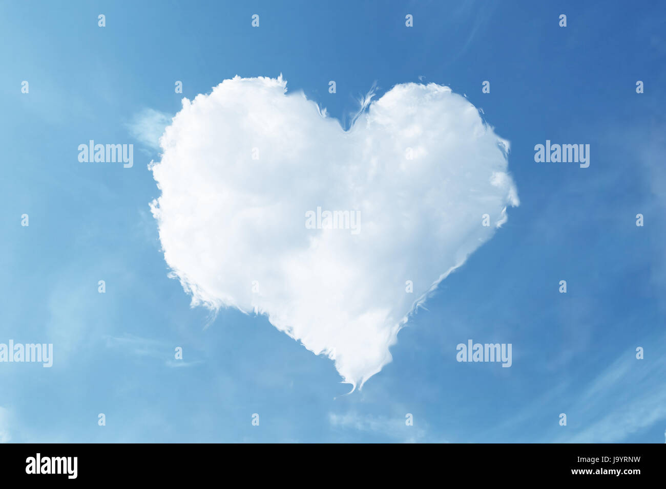 A forma di cuore in cloud il cielo blu Foto Stock
