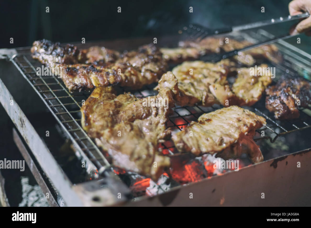 Sfocata di uomini asiatici sono in cottura barbecue Foto Stock