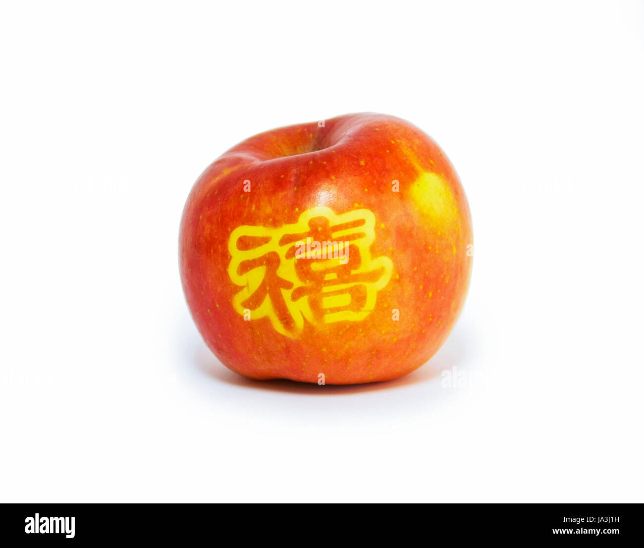 Red apple con il carving timbro della parola felice, lingua cinese Foto Stock