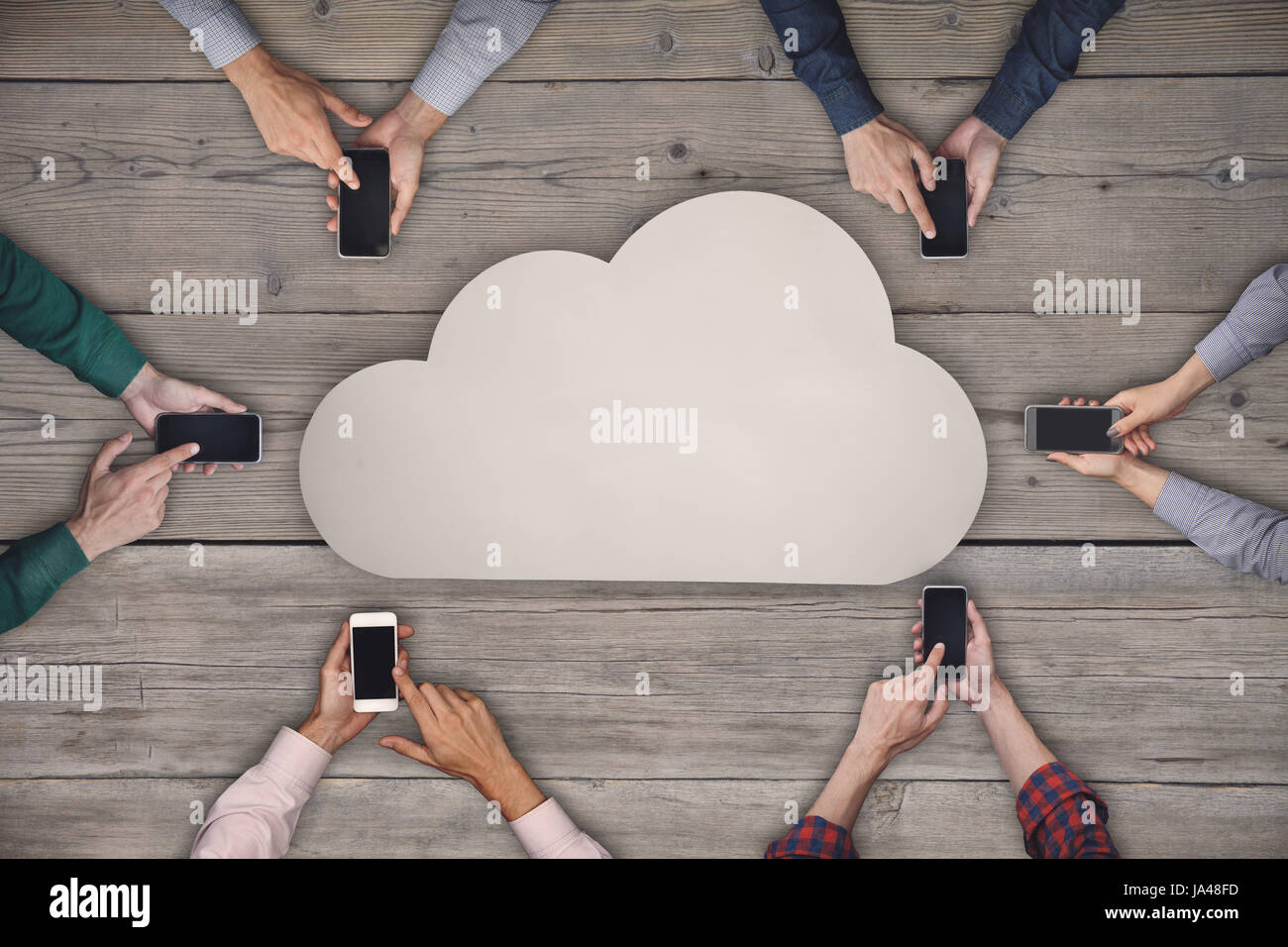 Il team Aziende a lavorare sugli smartphone. Condivisione Cloud concetto wireless Foto Stock