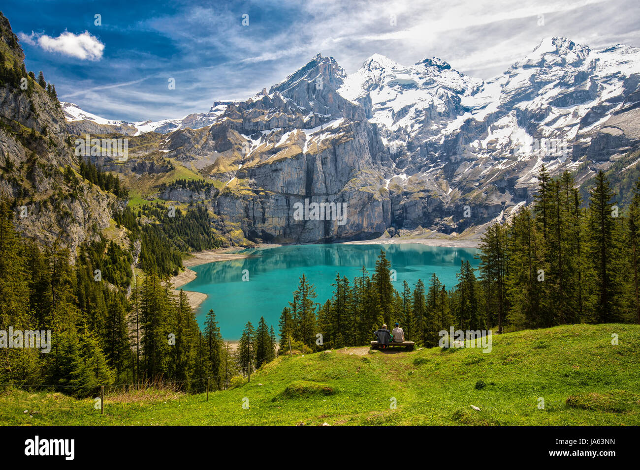 Incredibile tourquise Oeschinnensee con cascate, chalet in legno e Alpi Svizzere, Berner Oberland, Svizzera. Foto Stock