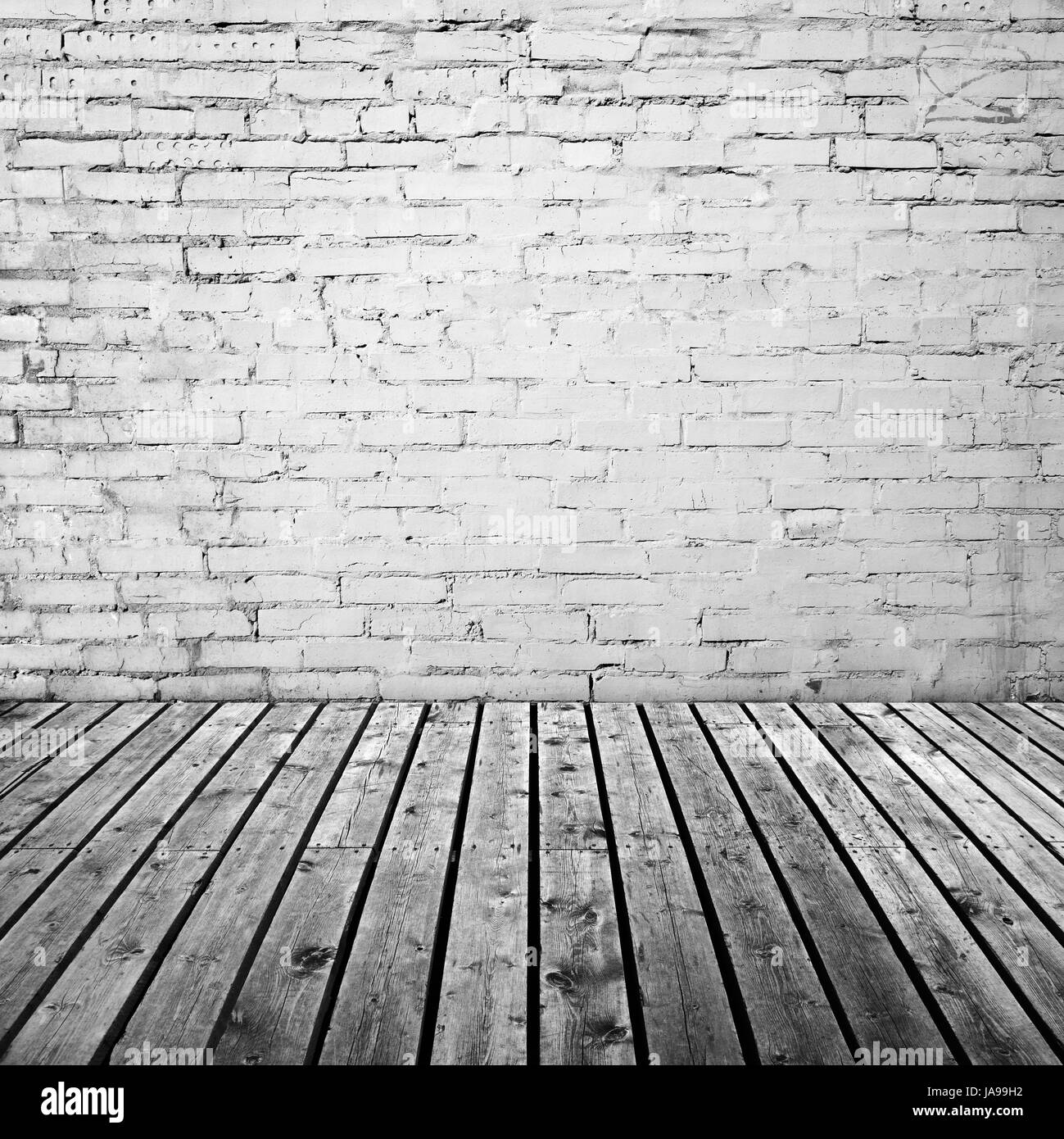 Bianco parete in mattoni grigi e pavimento in legno, abstract sbozzato di fondo interna Foto Stock