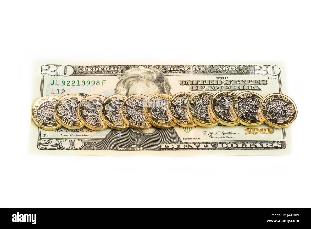 British una libbra di monete su un Dollaro statunitense Bill Foto Stock