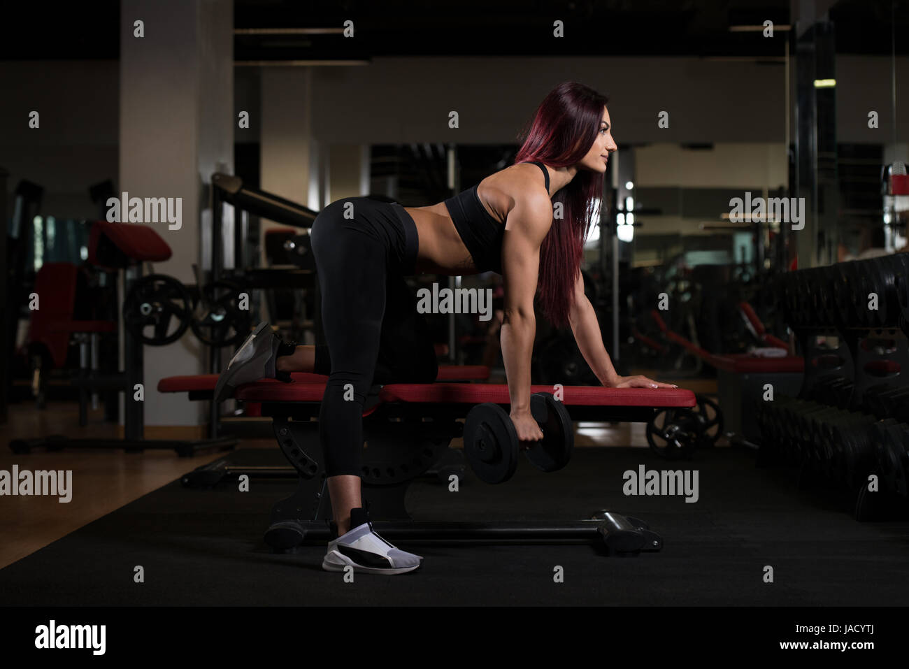 Atleta lavorando fuori indietro in una palestra con pesi Foto Stock