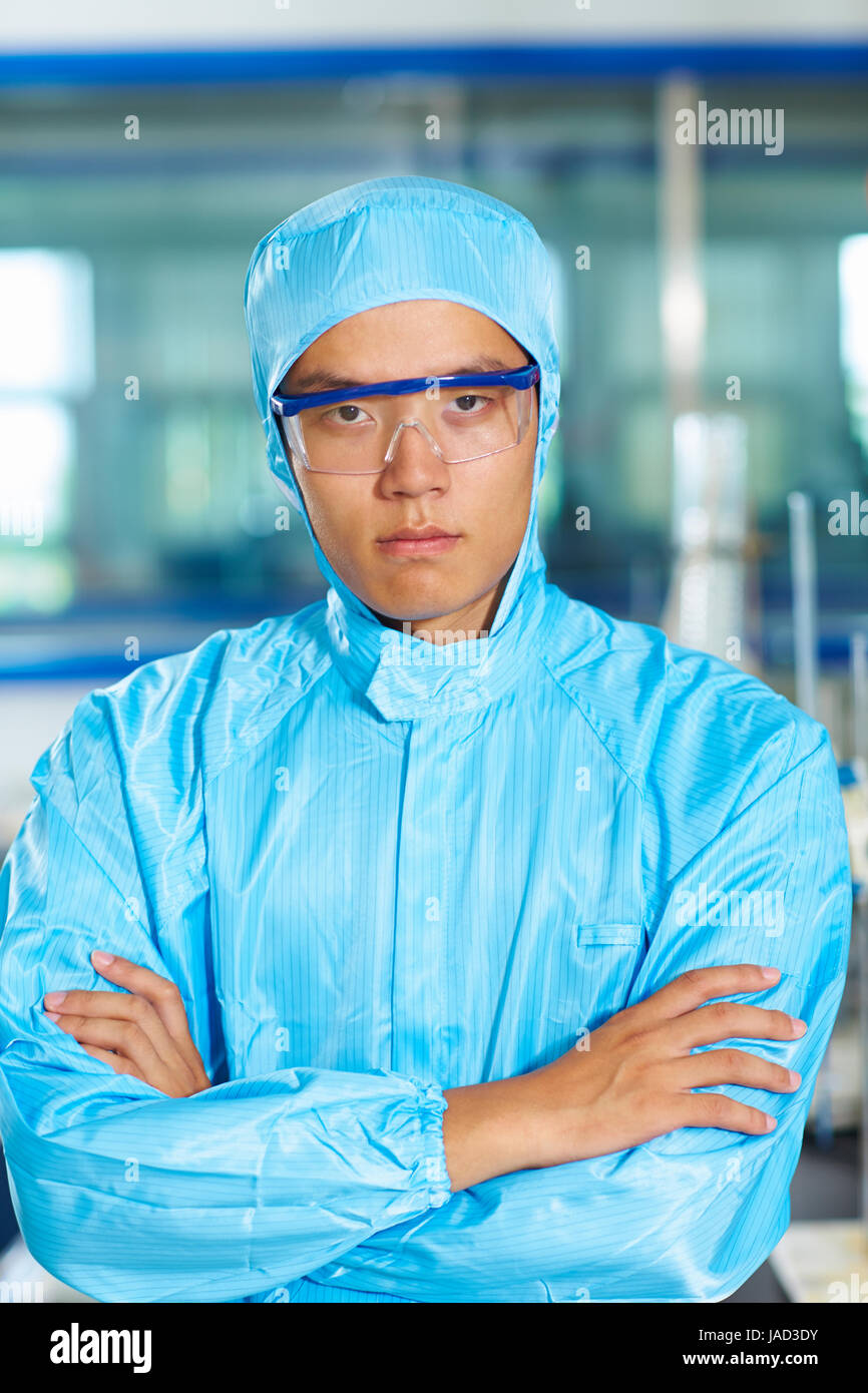Un maschio laboratorio cinese scienziato che lavora presso il laboratorio con le provette per la prova Foto Stock