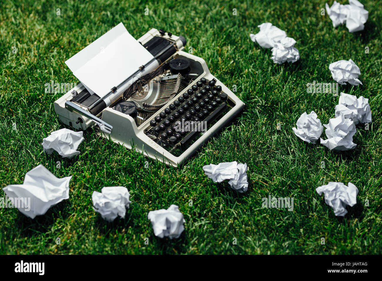 Foto della vecchia macchina da scrivere su un prato verde con un foglio di carta  Foto stock - Alamy