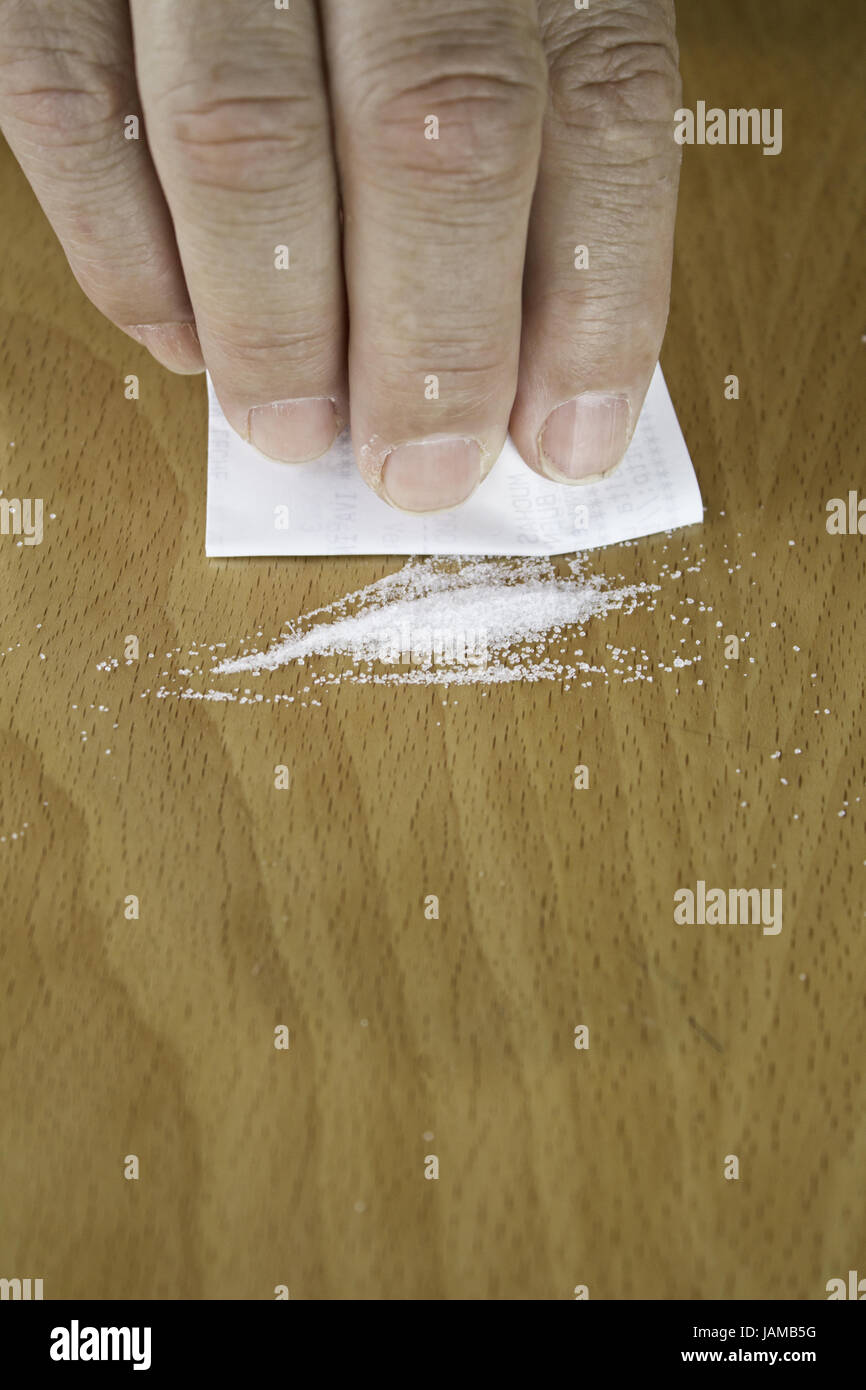Facendo una linea di cocaina sul tavolo in un bar, la droga e la tossicodipendenza Foto Stock