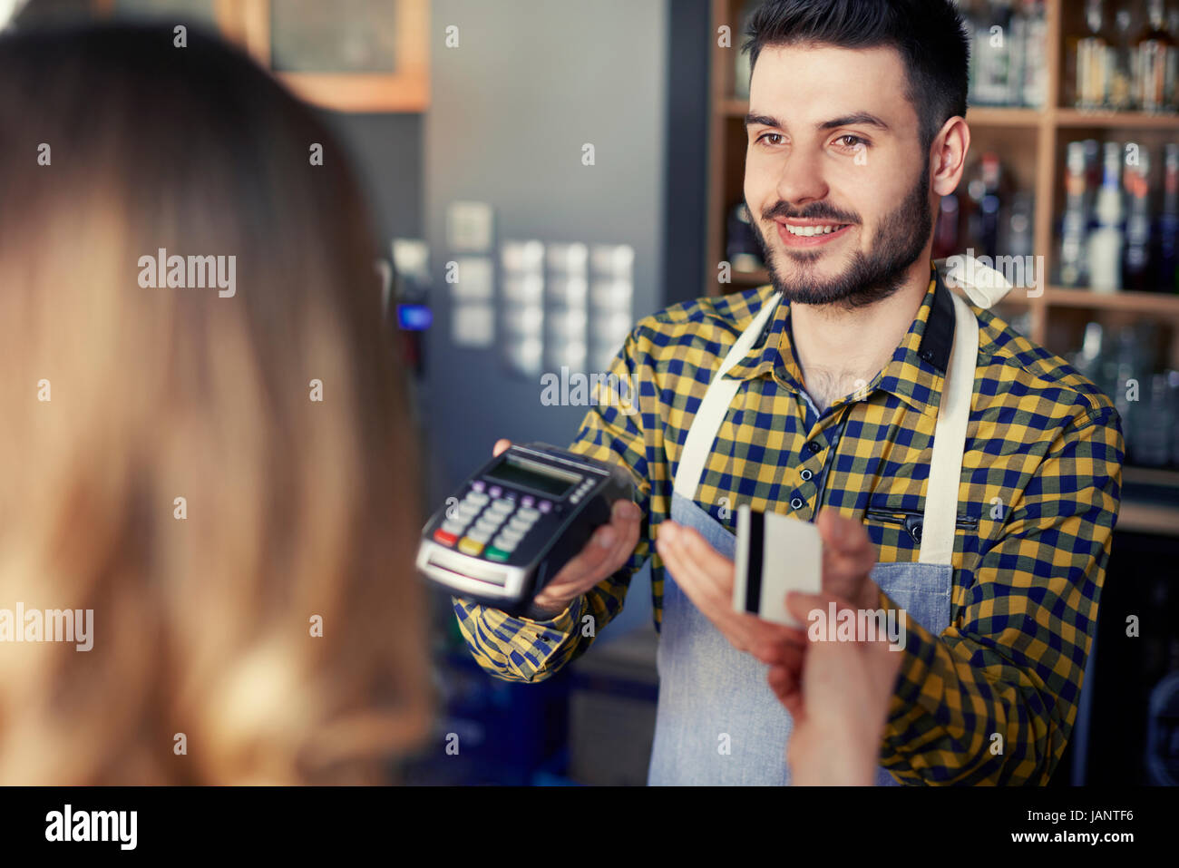 Il cliente di pagare con carta di credito nel caffè Foto Stock