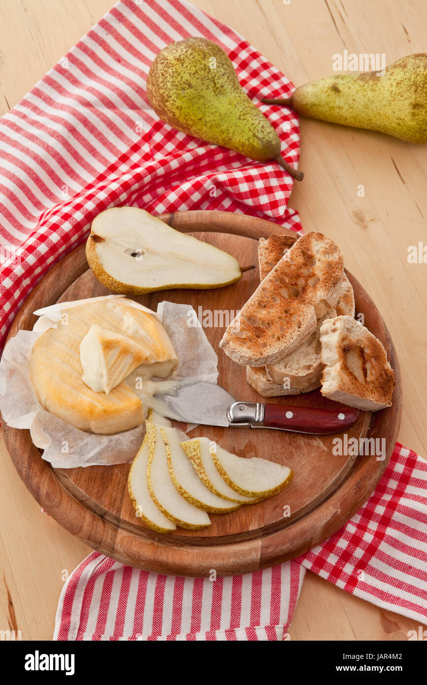 Kaese, Brot und frischen Birnen auf Schneidebrett Foto Stock