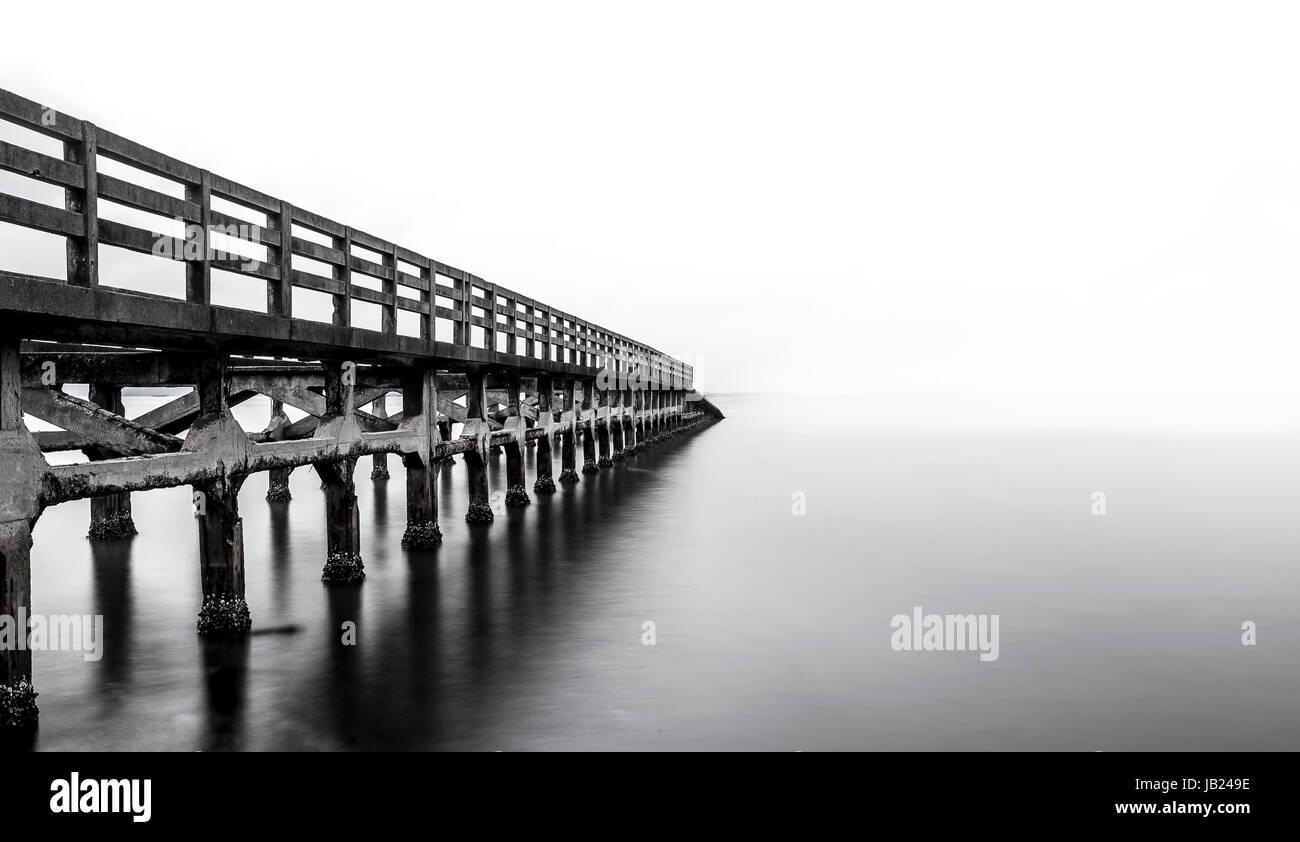 Una lunga esposizione di un vecchio ponte in Cambogia Beach - Kep beach - rovina ponte in bianco e nero Foto Stock