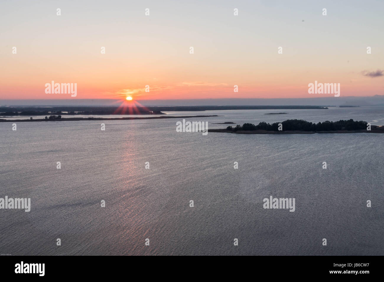 Alba sul grande fiume. Il sole è nel bordo sinistro della cornice. Foto Stock Alba sul grande fiume. Il sole è nel bordo sinistro della cornice. Foto Stock