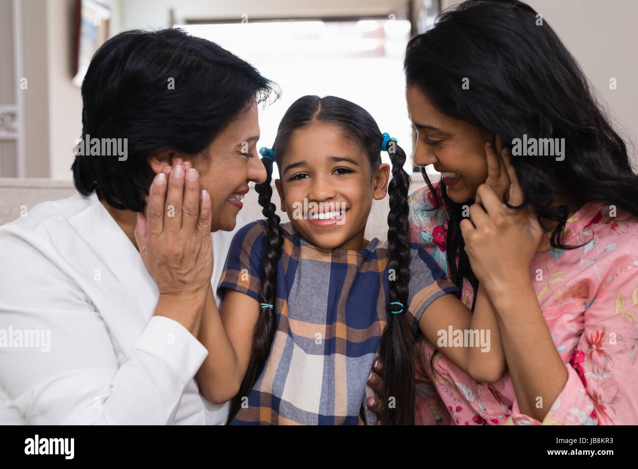 Ritratto di carina ragazza sorridente con la madre e la nonna a casa Foto Stock