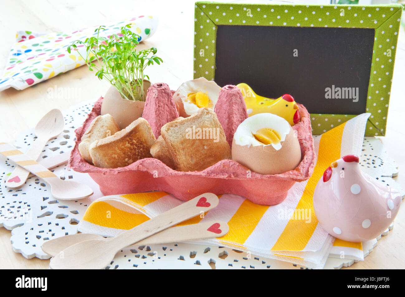 Gekochte Fruehstueckseier mit Salz, Pfeffer und kleinem Toastbrot Foto Stock