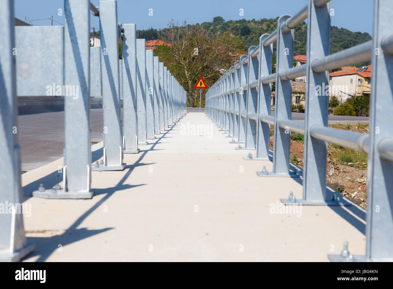 Ponte in acciaio passaggio pedonale su fiume in Grecia con il cartello stradale alla fine del passaggio Foto Stock