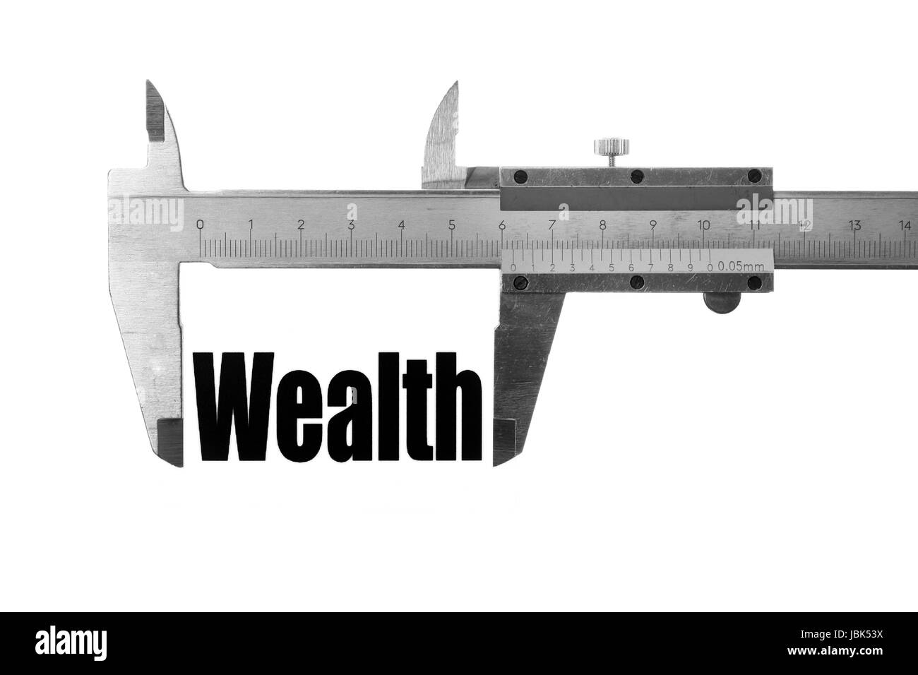 Immagine ravvicinata di un calibro misura la parola "ricchezza". Foto Stock