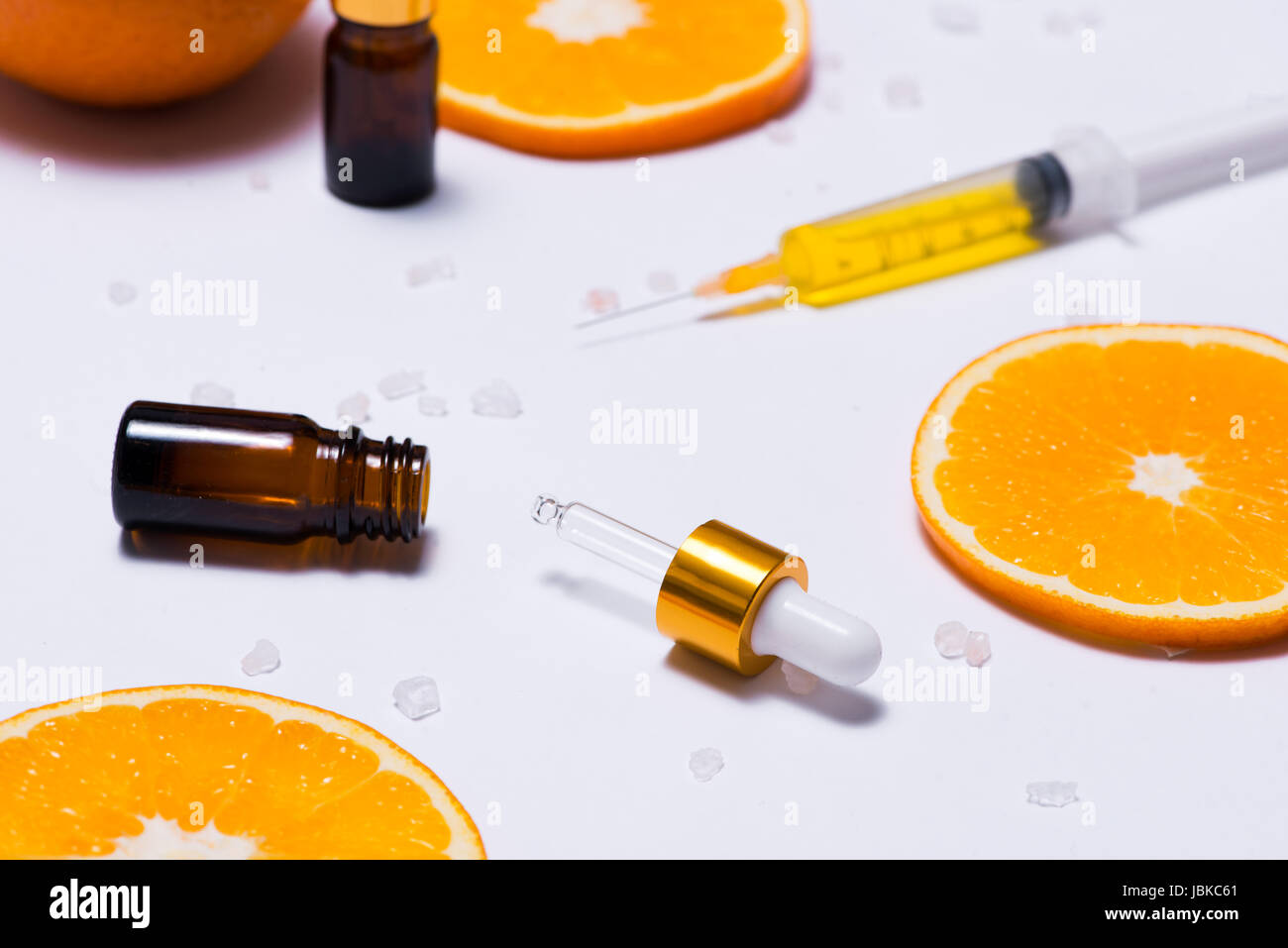 Il Branding mock-up. Olio essenziale naturale, bottiglia di cosmetici contenitori con fettine di arancia. Foto Stock