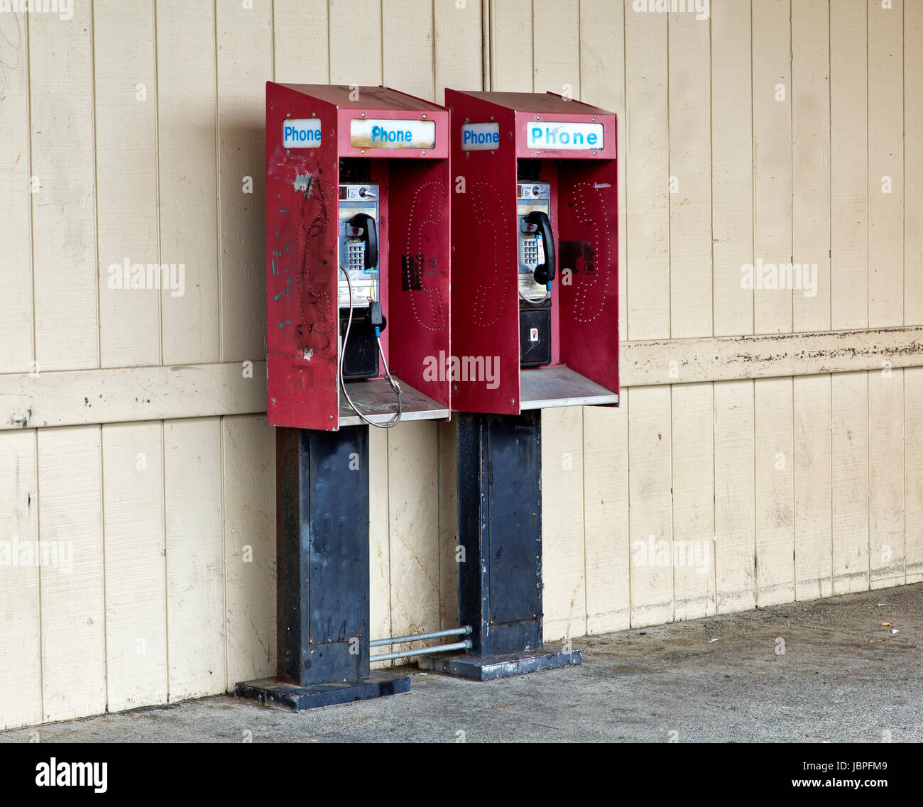 Abbandonato a gettone telefoni pubblici a pagamento con moneta slot di rilascio. Foto Stock