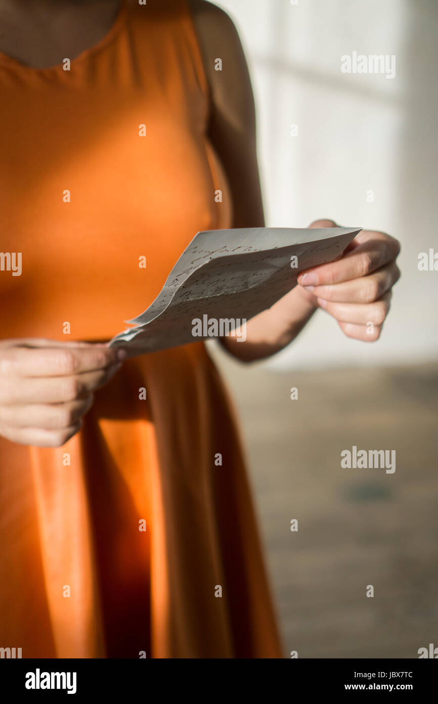 In prossimità di una giovane donna di mani tenendo una lettera Foto Stock