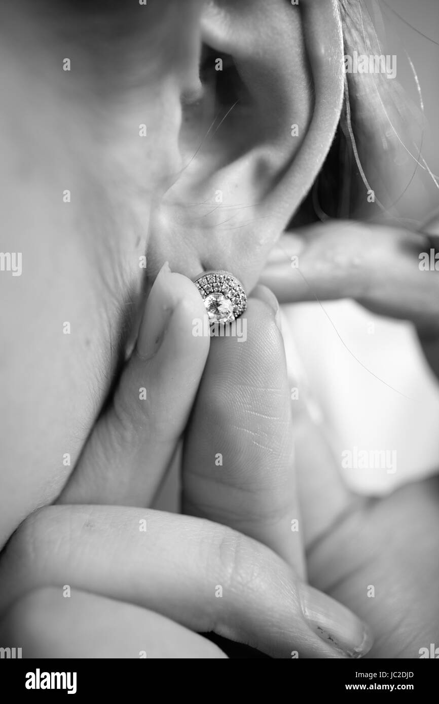 Ingrandimento di foto in bianco e nero di donna mettendo su errare con diamante Foto Stock