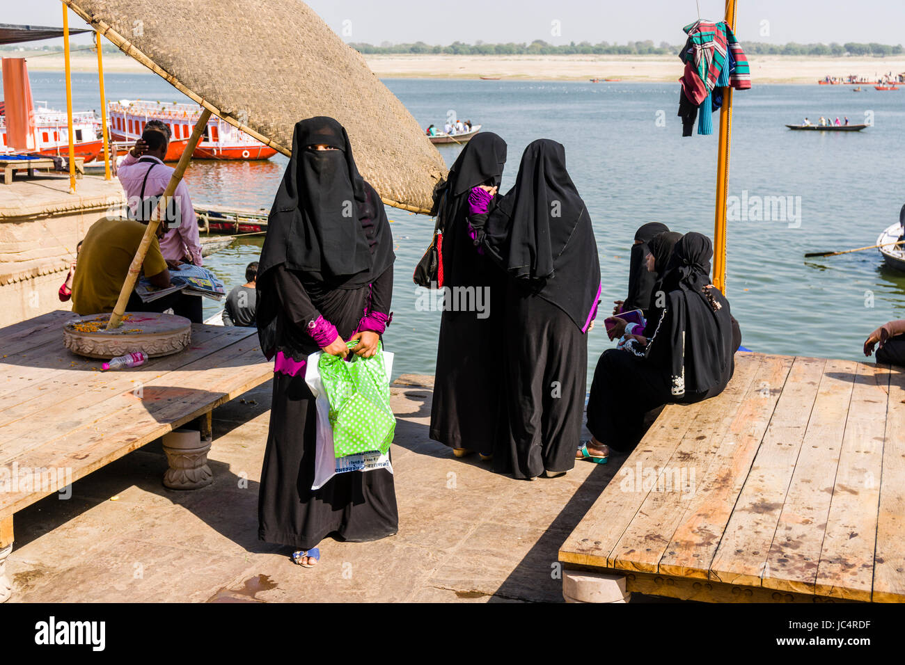 Un gruppo di donne musulmane, vestita di nero lo chador è in visita a dashashwamedh ghat, principale ghat, nel sobborgo godowlia Foto Stock