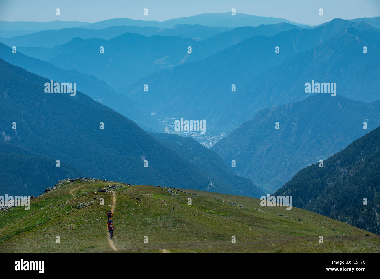 Un gruppo di appassionati di mountain bike cavalcare un sentiero ad alta nei Pirenei, Andorra. Foto Stock
