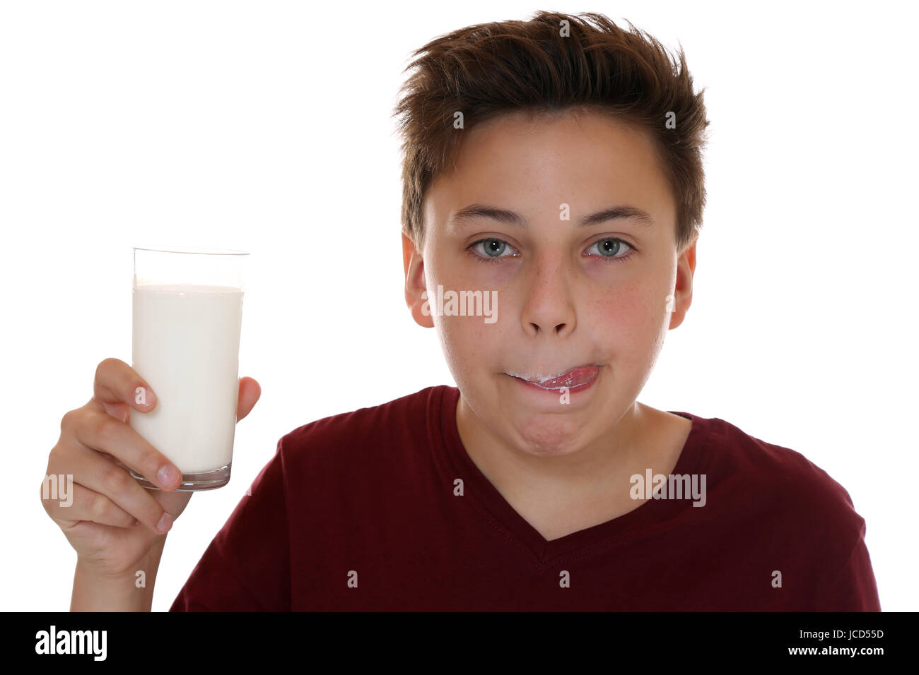 Gesunde Ernährung Junge trinkt Milch und leckt den Mund ab, isoliert vor einem weissen Hintergrund Foto Stock