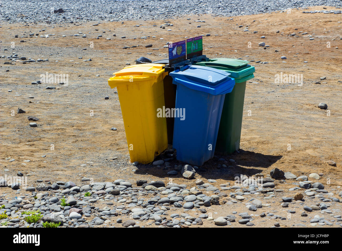 Con codice colore impennata cassonetti per il riciclaggio su una spiaggia di Playa Las Americas in Teneriffe Foto Stock