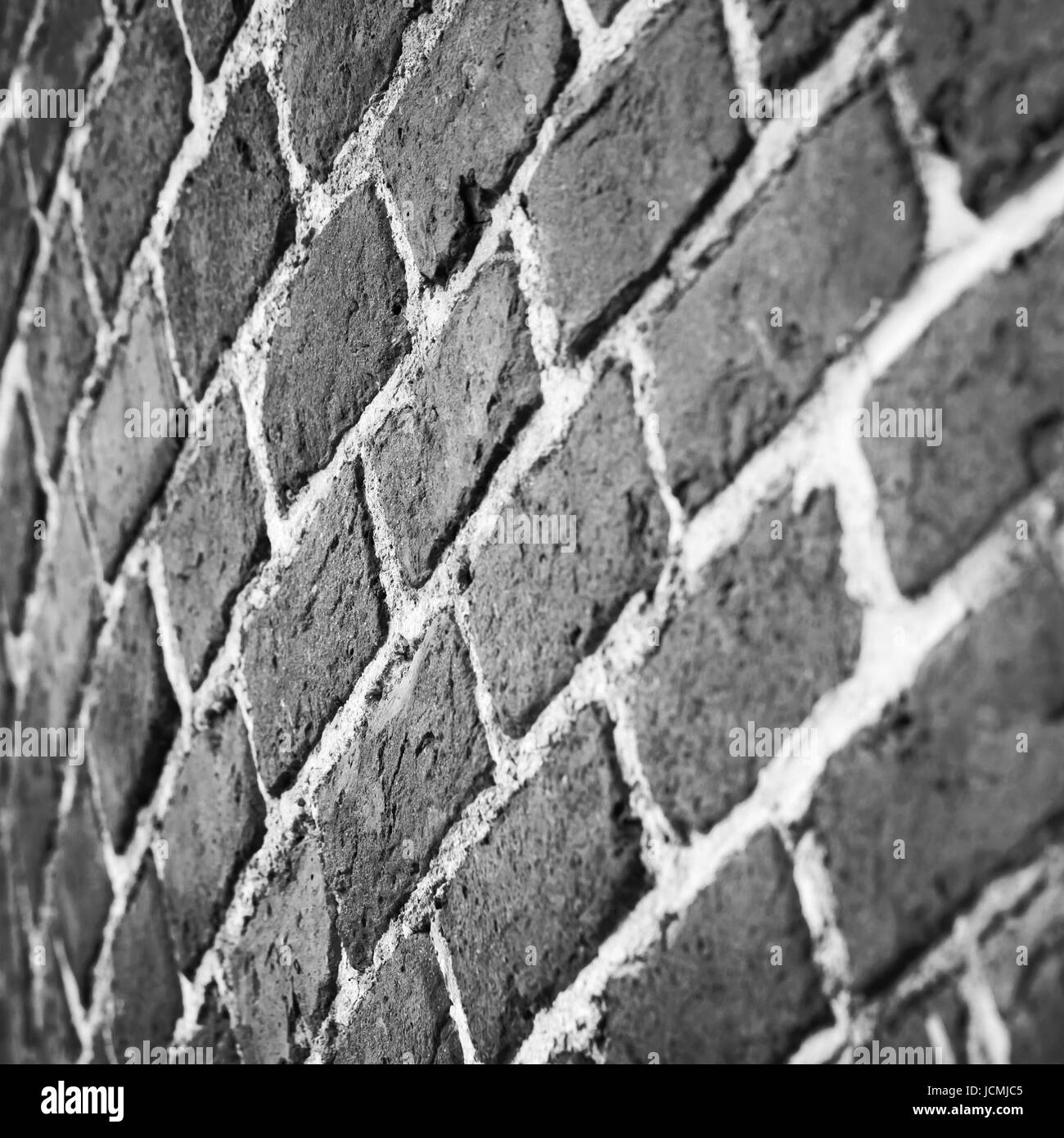 Grigio scuro round di muro di mattoni pattern. Sfondo fotografico con il fuoco selettivo Foto Stock