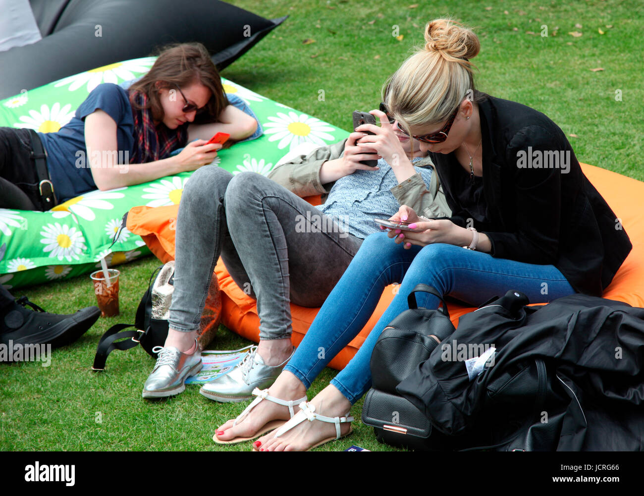 Giovani donne sui telefoni cellulari al gusto di Dublino Foto Stock